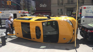 Woman Killed Crossing On Manhattan Street:Taxi Flips Over And Lands On Her