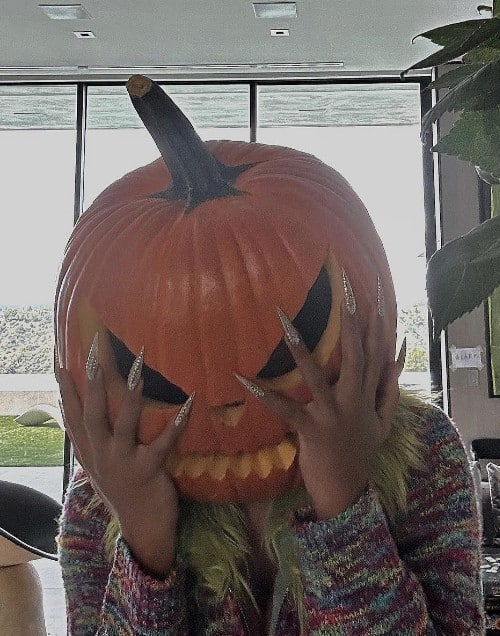 Megan Thee Stallion is having a hot girl halloween with her glittery nails and pumpkin theme.