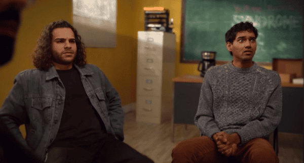 Young adults sitting in a classroom discussion, emphasizing diversity and engagement in educational environments, with focus on student participation and learning activities.